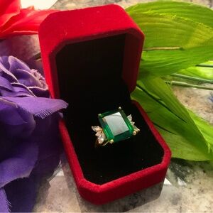 Lab created green emerald and Moissanite  set in 18k gold over silver. Size 7.5